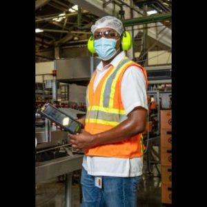Jerome McGregor, total productivity management manager at Red Stripe, brandishing the latest innovation to manufacturing process, One2Improve. 
