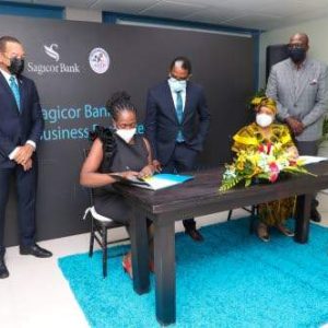 Chorvelle Johnson Cunningham (seated, left), CEO, Sagicor Bank Jamaica, signs the memorandum of understanding that solidifies the public-private partnership between the financial institution and Jamaica Business Development Corporation (JBDC). Looking on are (from left) Michael Willacy, vice president – retail and SME banking, Sagicor Bank Jamaica; Dr Norman Dunn, minister of state in the Ministry of Industry, Investment and Commerce; Valerie Veira (seated), CEO, JBDC; and Harold Davis, Deputy CEO, JBDC.