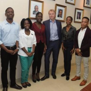Wed Edens (third right), chairman and CEO of New Fortress Energy (NFE), stands with the first cohort of NFE’s tertiary scholarship recipients at The University of the West Indies. From left: Jordan Hayles (electrical engineering), Crystal Duncombe (medicine), Jade McGann (medical sciences), Rickel Williams (civil engineering) and Gary McDonald (law). 